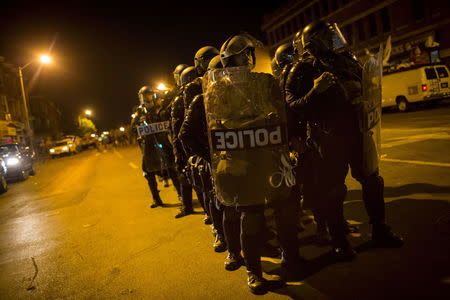 Police are seen along Pennsylvania Avenue two days after it was looted and set ablaze in protest against the death of Freddie Gray, a 25-year-old black man who died in police custody, in Baltimore, Maryland April 29, 2015. REUTERS/Eric Thayer