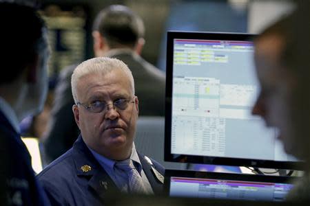 Traders work on the floor of the New York Stock Exchange February 3, 2014. REUTERS/Brendan McDermid