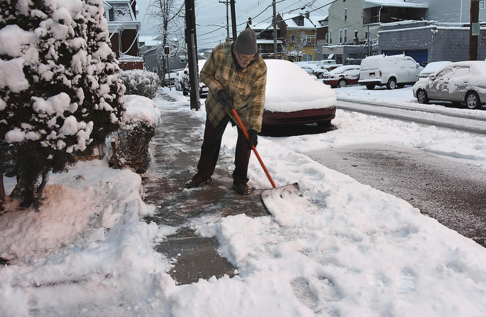 <p>Joe Hrroghi cleans off the sidewalk on Fisk Street, in the Lawrenceville section of Pittsburgh, Thursday, Feb. 9, 2017. A powerful, fast-moving storm swept through the northeastern U.S. Thursday, making for a slippery morning commute and leaving some residents bracing for blizzard conditions. (Photo: Darrell Sapp/Pittsburgh Post-Gazette via AP) </p>