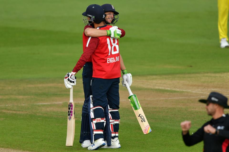 England's Jos Buttler (L) embraces England's Moeen Ali (R) as England celebrate their victory in the international Twenty20 cricket match between England and Australia. 