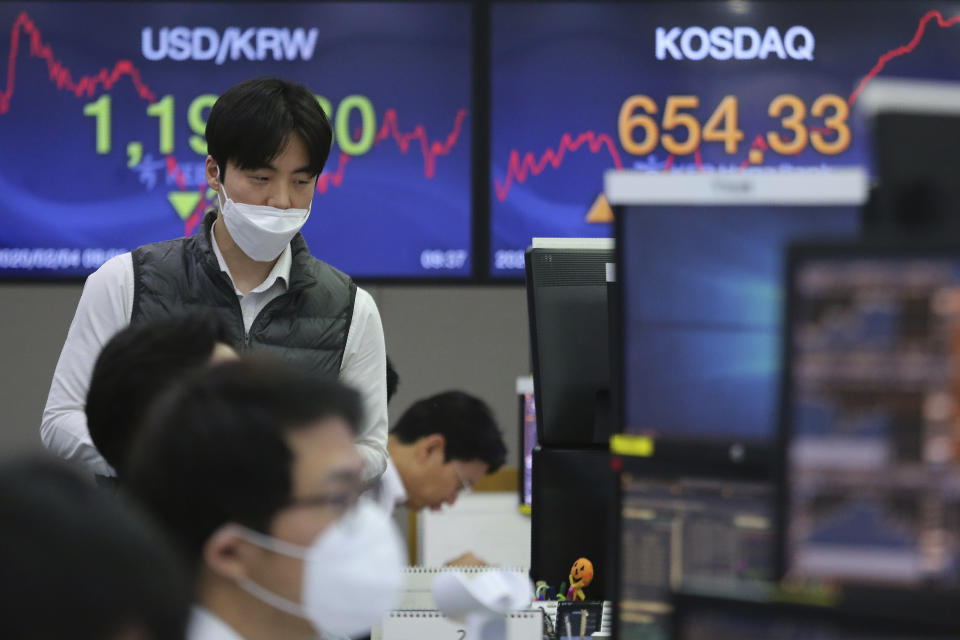 A currency trader watches monitors at the foreign exchange trading room of the KEB Hana Bank headquarters in Seoul, South Korea, Tuesday, Feb. 4, 2020. Shares advanced in Asia on Tuesday, with the Shanghai Composite up 0.2% after a rebound on Wall Street overnight. (AP Photo/Ahn Young-joon)