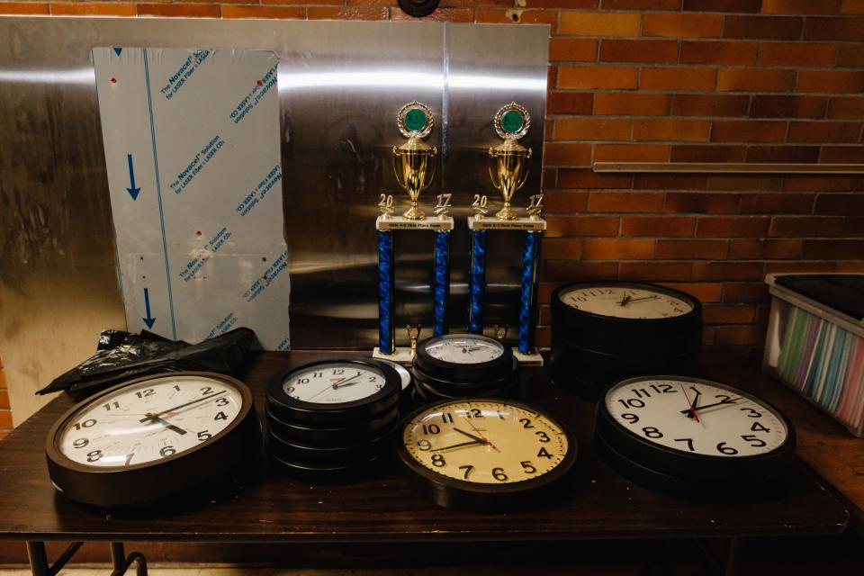 Clocks are seen stacked, ready for auction, at the Bolivar School.