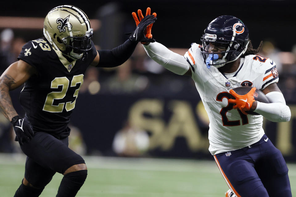 Chicago Bears running back D'Onta Foreman (21) runs next to New Orleans Saints cornerback Marshon Lattimore (23) during the first half of an NFL football game in New Orleans, Sunday, Nov. 5, 2023. (AP Photo/Butch Dill)
