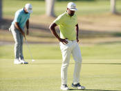 Tony Finau, right, reacts after missing a putt on the 10th green as Max Homa putts, back left, during the first playoff hole in the final round of the Genesis Invitational golf tournament at Riviera Country Club, Sunday, Feb. 21, 2021, in the Pacific Palisades area of Los Angeles. (AP Photo/Ryan Kang)