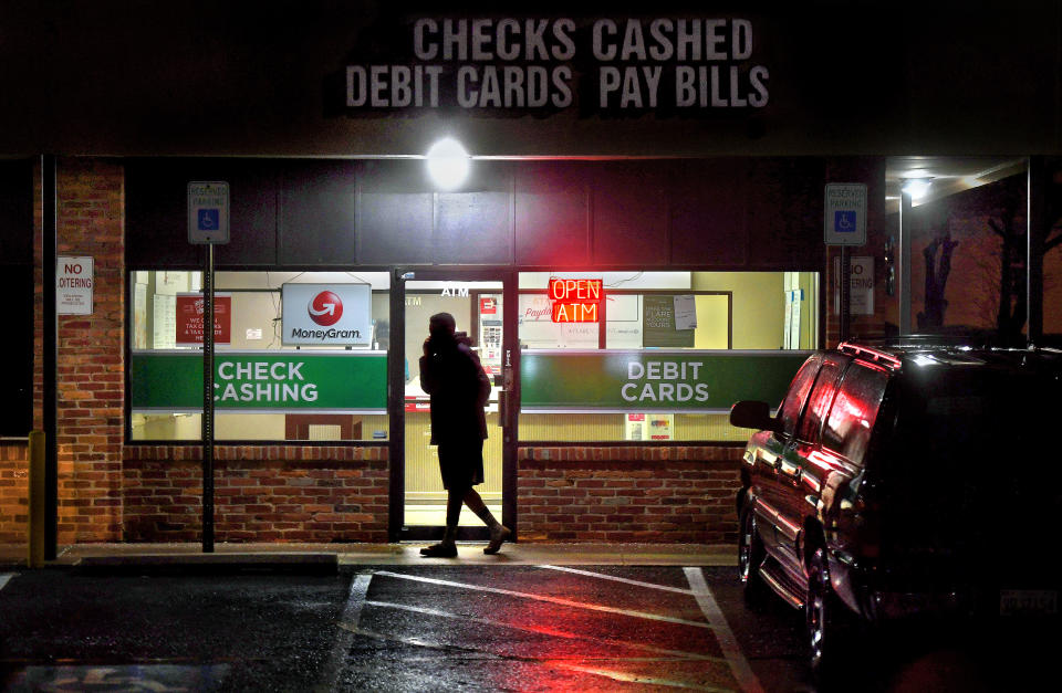 GAITHERSBURG, MD FEB 12: A customer leaves a payday loan store on Frederick Rd. in Gaithersburg, Maryland. The check cashing and payday loan services industry has thousands of branch offices all over the U.S. There are more payday lenders in the U.S. than McDonald's restaurants. There are various companies that offer payday loans for recurring expenses, unexpected expenses and paycheck cashing. The stores tend to be in urban and/or lower income areas. (Photo by Michael S. Williamson/The Washington Post via Getty Images)