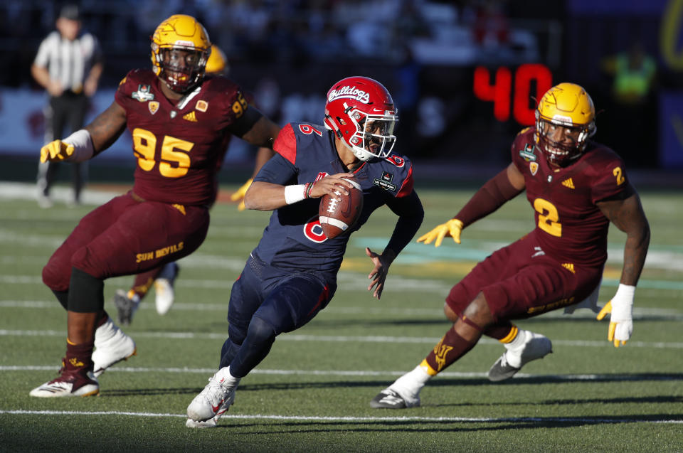 Fresno State quarterback Marcus McMaryion runs from Arizona State defensive players during the second half of the Las Vegas Bowl NCAA college football game, Saturday, Dec. 15, 2018, in Las Vegas. (AP Photo/John Locher)