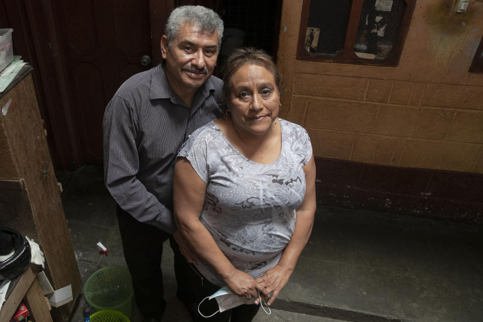 Fabio Rodolfo Vasquez and his wife, Maria Moreno, pose for photo in the home of Moreno's mother, in the San Pedrito neighborhood of Guatemala City, Thursday, Sept. 17, 2020. A homemade video where they dance to "Danger" by The Flirts went viral, and the couple, who met on the dance floor more than 30 years ago, became an overnight sensation. (AP Photo/Moises Castillo)