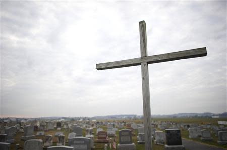 A cross and a graveyard are seen in Bart Township, Pennsylvania, December 1, 2013. REUTERS/Mark Makela