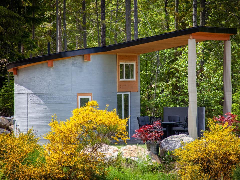 the exterior of the Fibonacci House among trees and grass