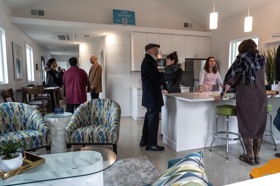 People look inside Detroit's first 3D-printed house before a ribbon-cutting ceremony for the home on Sheridan Street on the east side of the city on Thursday, Feb. 22, 2024.