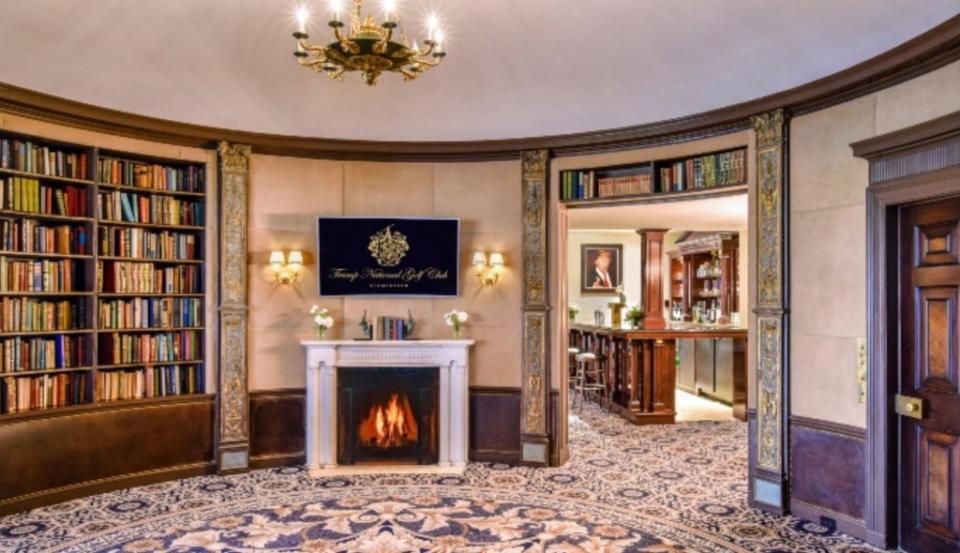 The library with a fireplace and a wet bar in the adjacent room. Trump National Golf Club
