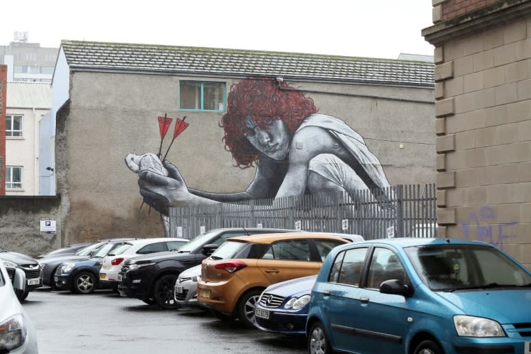 Work in Belfast by French artist MTO, "The Son of Protagoras," of a child holding a dove killed by two arrows, one representing Catholicism, the other Protestantism