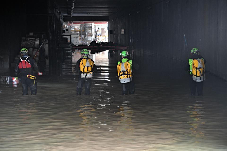 Speleological alpine rescuers look for missing persons at an underpass in Cesena on May 17, 2023 after heavy rains have caused major floodings in central Italy, where trains were stopped and schools were closed in many towns while people were asked to leave the ground floors of their homes and to avoid going out.