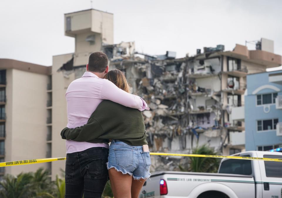 People observe the partially collapsed Champlain Towers South condo in Surfside, Fla., on June 25, 2021.