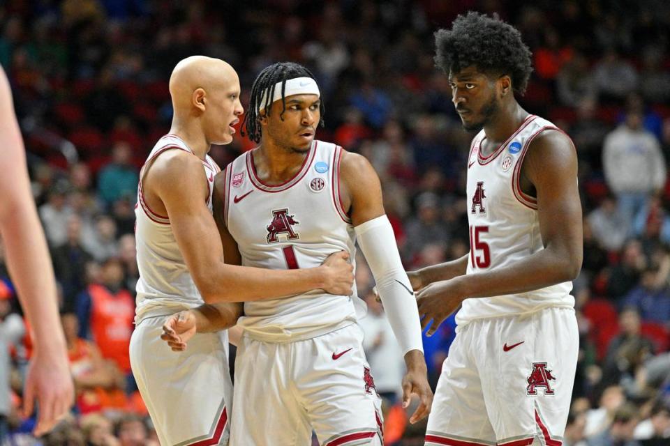 Arkansas Razorbacks guard Jordan Walsh (left) and forward Makhi Mitchell (right) talk with Ricky Council IV (1) during the first half at Wells Fargo Arena on March 16, 2023.