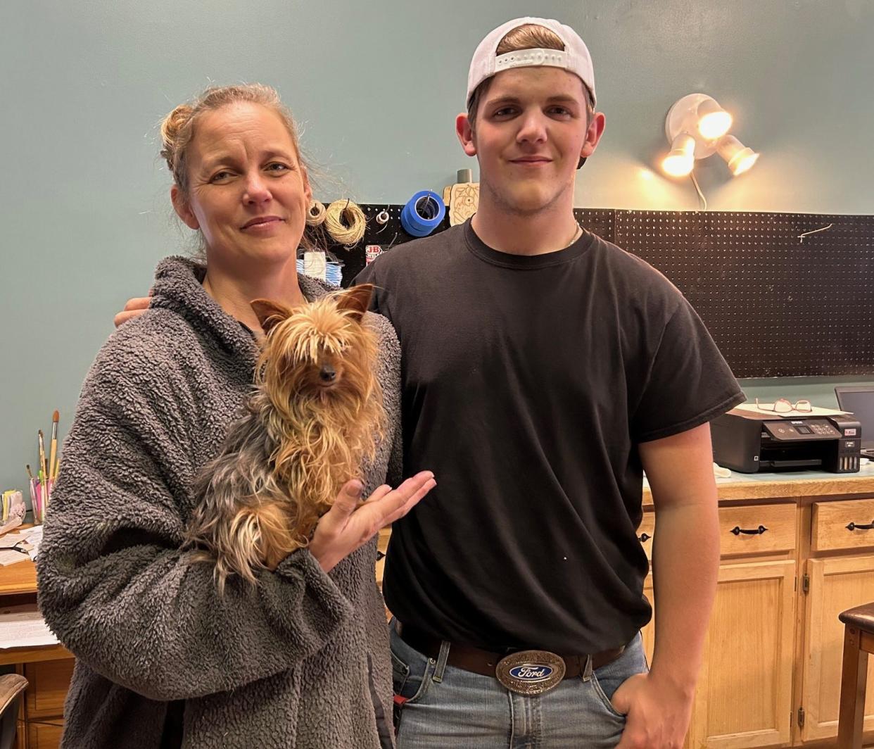 Erika Taylor in her new store with her dog and business mascot, JoJo, and her son, Hunter.