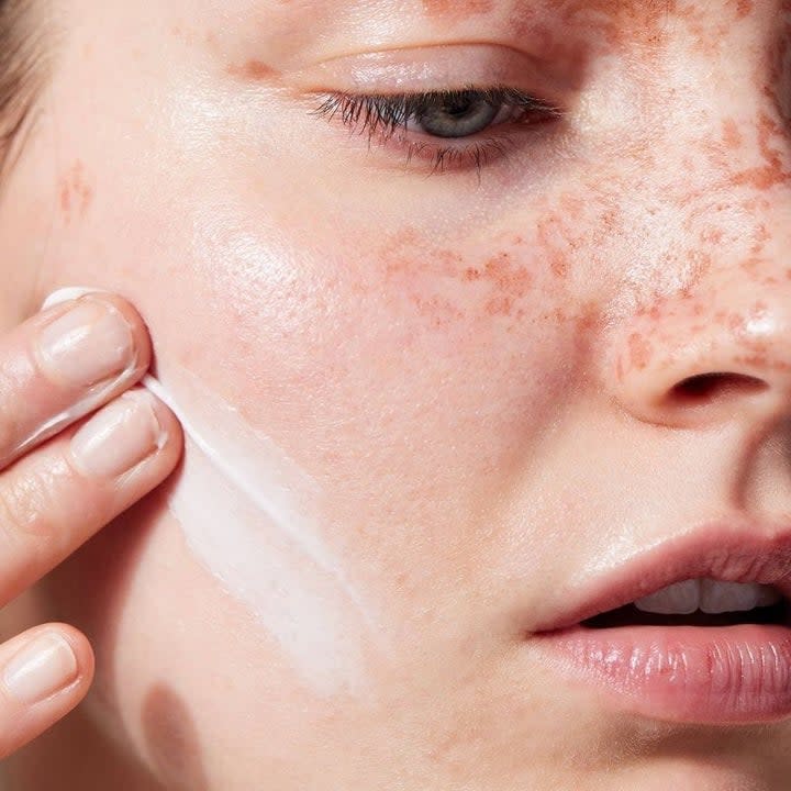 Model applying the face cream