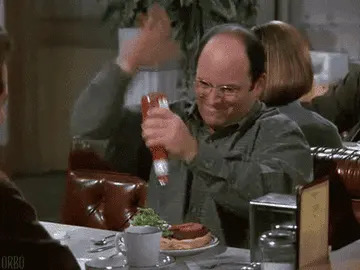 George from "Seinfeld" pouring Ketchup on his burger.