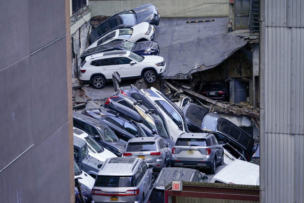 FILE — Cars are seen piled on top of each other at the scene of a partial collapse of a parking garage in the Financial District of New York, April 18, 2023, in New York. After the deadly collapse of a parking structure in lower Manhattan, New York City building officials swept through dozens of parking garages and ordered four of them to immediately shutter because of structural issues that “deteriorated to the point where they were now posing an immediate threat to public safety.” (AP Photo/Mary Altaffer, File)
