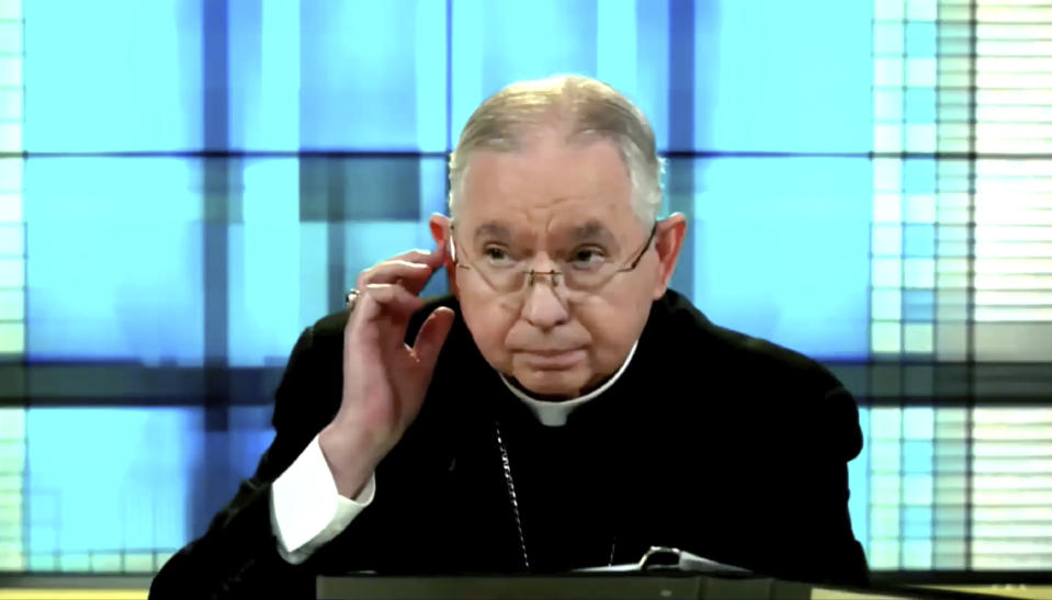 In this image taken from video, U.S. Conference of Catholic Bishops president and Los Angeles Archbishop José Gomez of Los Angeles confers with staff to alert the next speaker during their virtual assembly on Wednesday, June 16, 2021.(United States Conference of Catholic Bishops via AP)