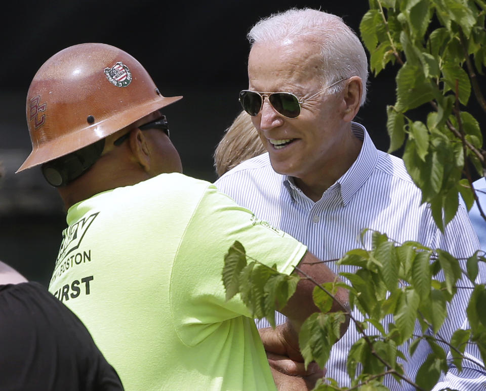 Former vice president and Democratic presidential candidate Joe Biden speaks to a worker on Wednesday, June 5, 2019, at a park in Boston being constructed in honor of Martin Richard, the youngest victim of the 2013 Boston Marathon bombings. (AP Photo/Steven Senne)