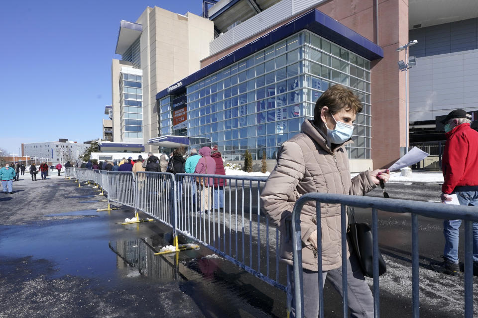 People enter a socially distanced line to get their COVID-19 vaccinations at Gillette Stadium, Monday, Feb. 8, 2021, in Foxborough, Mass. (AP Photo/Steven Senne)