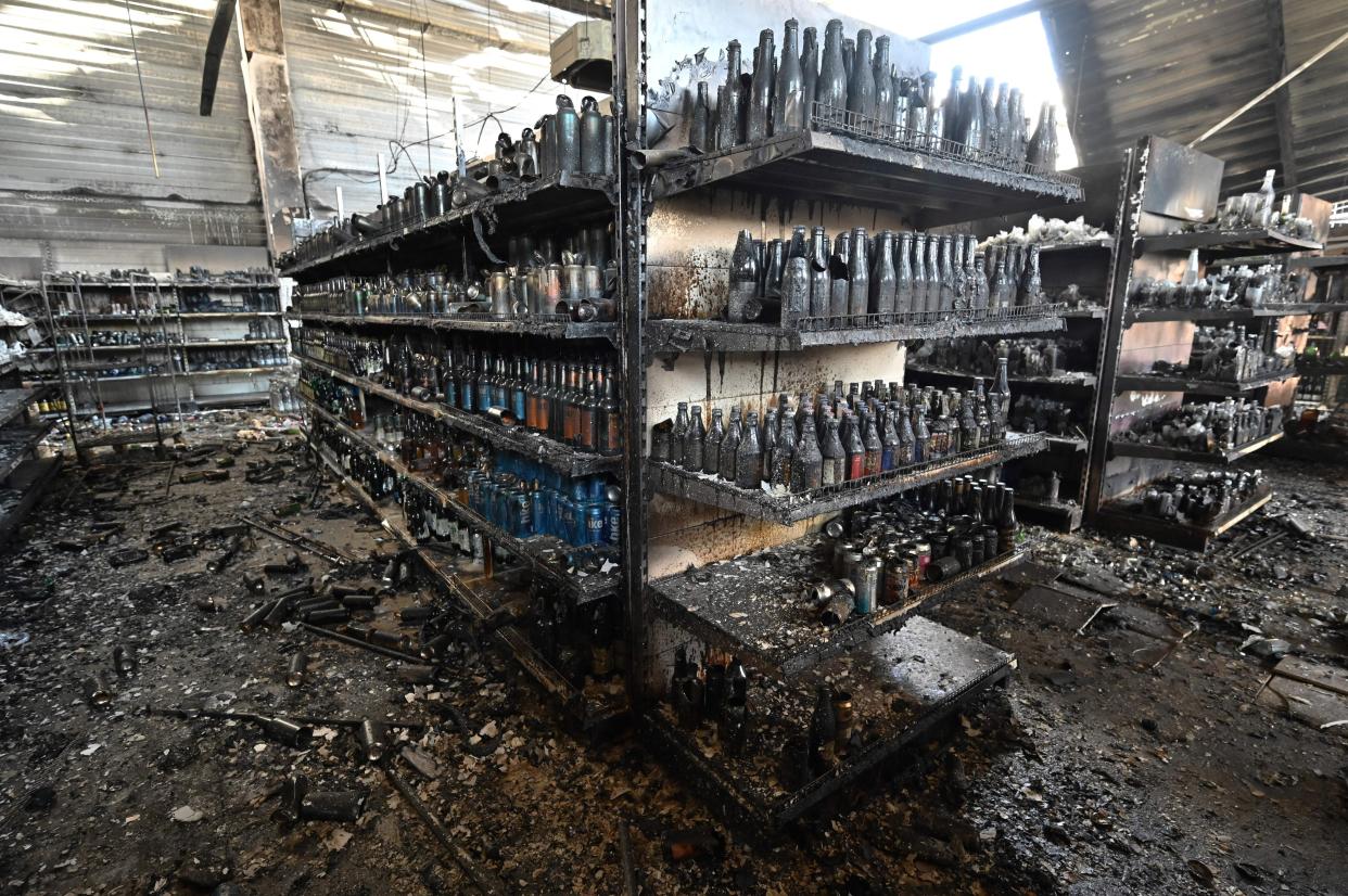 A photograph taken on June 28, 2022 shows charred goods in a grocery store of the destroyed Amstor mall in Kremenchuk, one day after it was hit by a Russian missile strike according to Ukrainian authorities. - A Russian missile strike on a crowded mall in central Ukraine killed at least 18 people in what Group of Seven leaders branded "a war crime" at a meeting in Germany where they looked to step up sanctions on Moscow. The leaders vowed that Russian President and those responsible would be held to account for June 27's strike in the city of Kremenchuk, carried out during the shopping mall's busiest hours. (Photo by Genya SAVILOV / AFP) (Photo by GENYA SAVILOV/AFP via Getty Images)