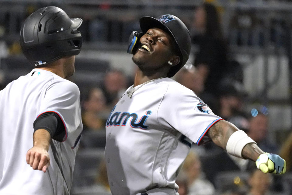 Miami Marlins' Jazz Chisholm Jr., right, celebrates with the bat boy as he returns to the dugout after hitting a solo home run off Pittsburgh Pirates starting pitcher Quinn Priester during the third inning of a baseball game in Pittsburgh, Saturday, Sept. 30, 2023. (AP Photo/Gene J. Puskar)