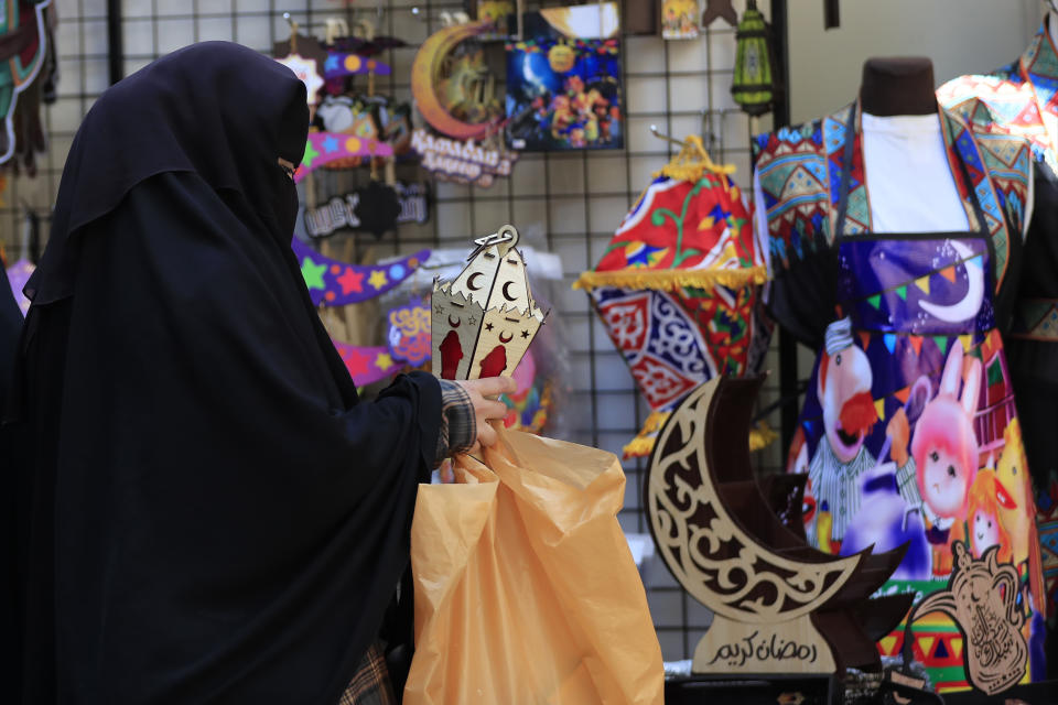 A Lebanese woman shops for decorations in preparation for the upcoming Islamic holy month of Ramadan, in the southern port city of Sidon, Lebanon, Tuesday, March 21, 2023.(AP Photo/Mohammed Zaatari)