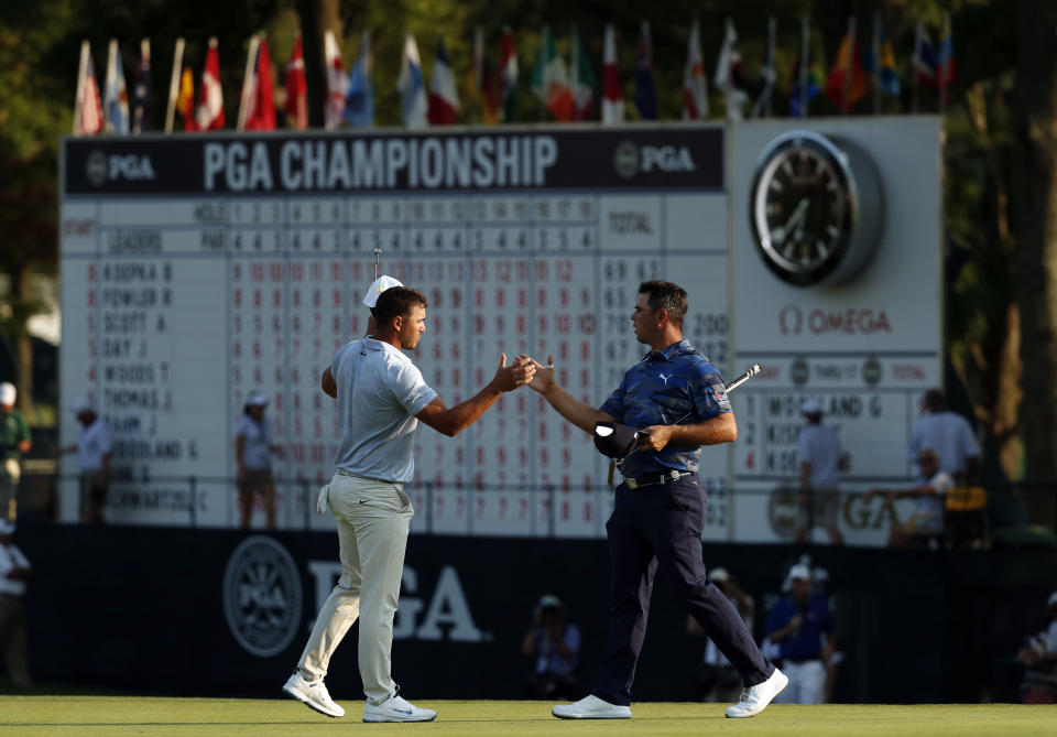 Brooks Koepka, left, and Gary Woodland shake hands following the third round of the PGA Championship golf tournament at Bellerive Country Club, Saturday, Aug. 11, 2018, in St. Louis. (AP Photo/Jeff Roberson)