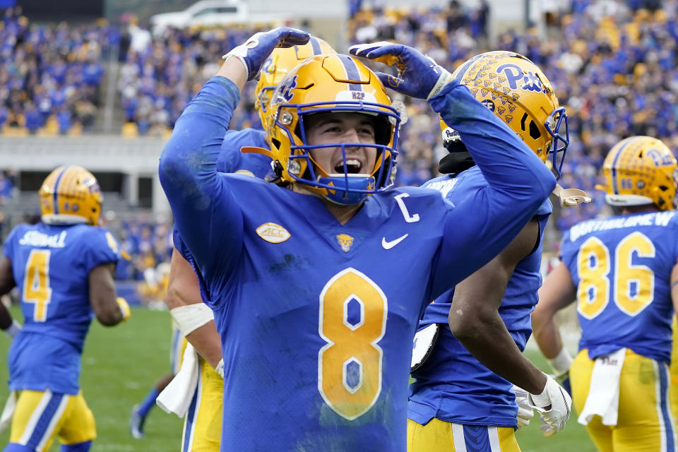 Pittsburgh quarterback Kenny Pickett (8) celebrates after throwing him a touchdown pass to wide receiver Jordan Addison (3) during the first half of an NCAA college football game against Clemson, Saturday, Oct. 23, 2021, in Pittsburgh. (AP Photo/Keith Srakocic)