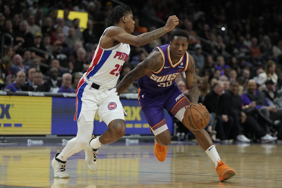 Phoenix Suns guard Saben Lee (38) drives on Detroit Pistons guard Jaden Ivey during the second half of an NBA basketball game, Wednesday, Feb. 14, 2024, in Phoenix. (AP Photo/Rick Scuteri)