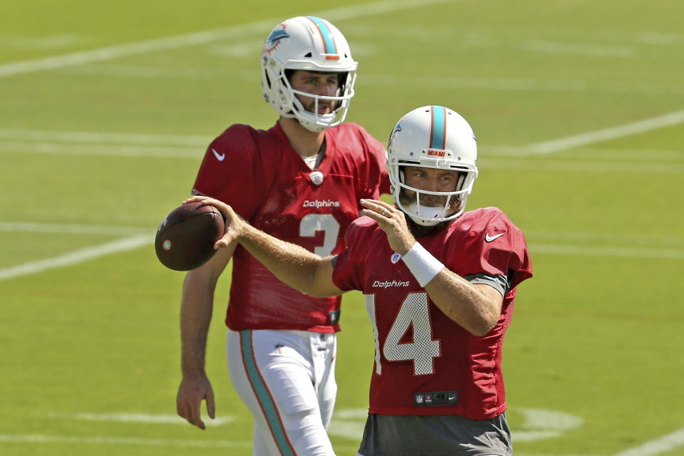 Miami Dolphins quarterbacks Ryan Fitzpatrick (14) and Josh Rosen (3) running drills during practice at the Baptist Health Training Facility at Nova Southeastern University on Wednesday, October 16, 2018, in Davie in preparation for their game against the Buffalo Bills on Sunday at New Era Field in New York. (David Santiago/Miami Herald via AP)