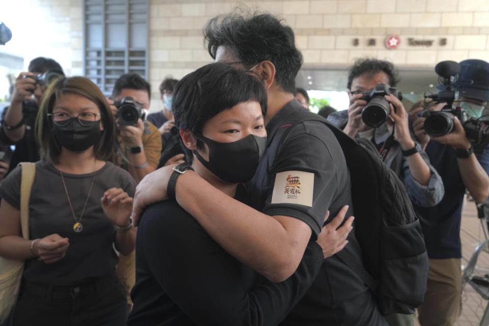 Hong Kong journalist Choy Yuk-ling, also known as Bao Choy, center left, hugs her supporter on her arrival at a court in Hong Kong Thursday, April 22, 2021. Choy appeared in court on Thursday for verdict on charges of making false statements while obtaining information from a vehicle database. Choy, a producer at public broadcaster Radio Television Hong Kong, was arrested in Nov 2020. She was involved in the production of an investigative documentary into the behavior of Hong Kong police during 2019 anti-government protests, after the force was accused of not intervening during a violent clash between protesters and a mob of men in a subway station. (AP Photo/Kin Cheung)