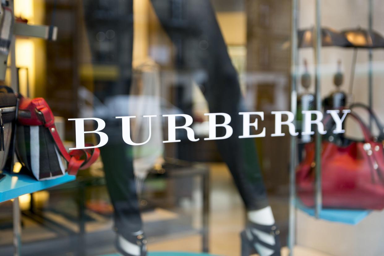 window display features contemporary fashions at a Burberry store in Paris