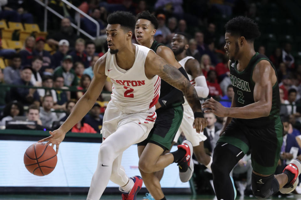 Dayton's Ibi Watson (2) moves the ball as George Mason's Xavier Johnson (2) defends during the first half of an NCAA college basketball game Tuesday, Feb. 25, 2020, in Fairfax, Va.(AP Photo/Luis M. Alvarez)