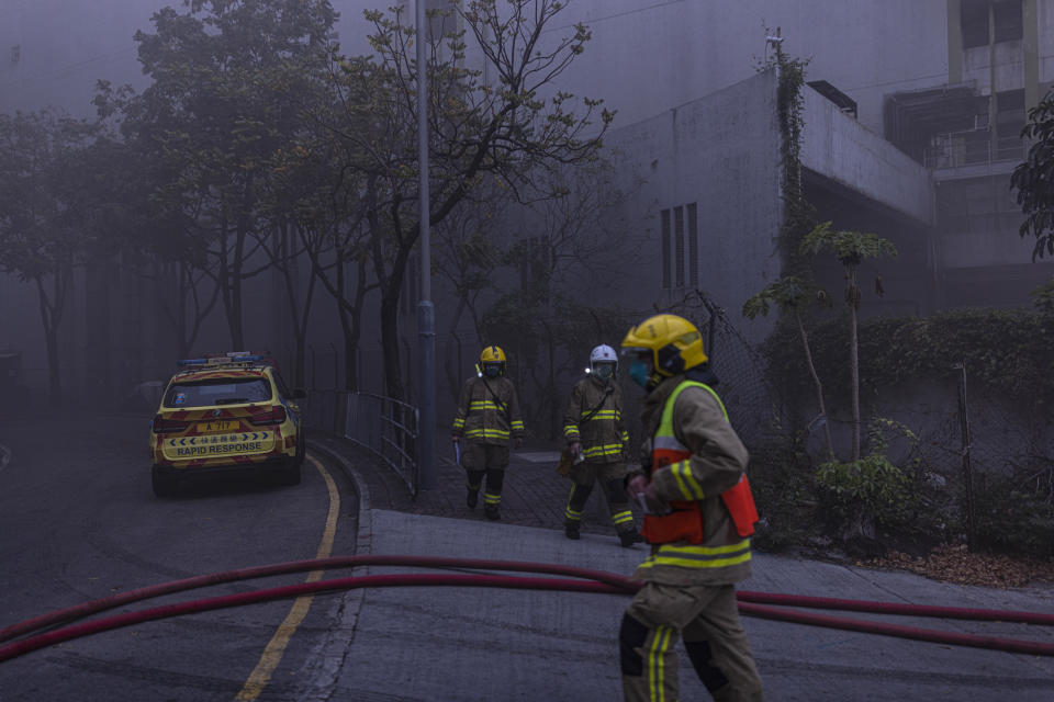 Firefighters battle a fire in Cheung Sha Wan, a residential and industrial area, in Hong Kong, Friday, March 24, 2023. Hong Kong firefighters were battling a blaze Friday at a warehouse that forced more than 3,000 people to evacuate, including students, police said. (AP Photo/Louise Delmotte)