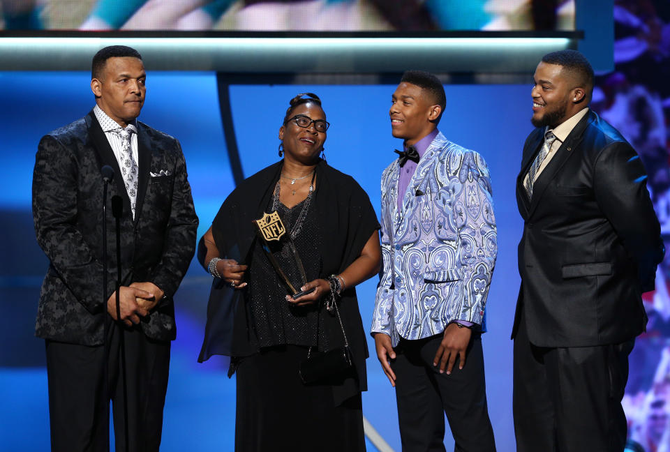 Caylin Newton, wearing the can’t-miss jacket, joins his family in accepting his brother Cam’s MVP award in 2016. (AP)