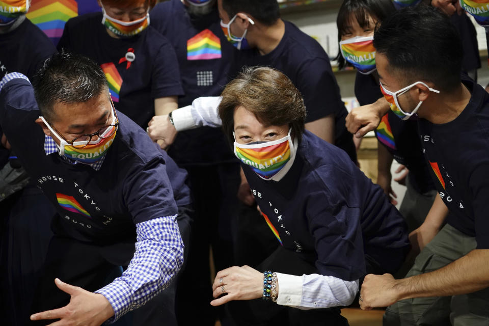 Tokyo 2020 Organizing Committee President Seiko Hashimoto, center, wearing a rainbow-colored mask poses for a photo with representatives and staff at Pride House Tokyo Legacy during her visit, in Tokyo Tuesday, April 27, 2021. Japan marked LGBTQ week with pledge to push for equality law before the Olympics. (AP Photo/Eugene Hoshiko, Pool)