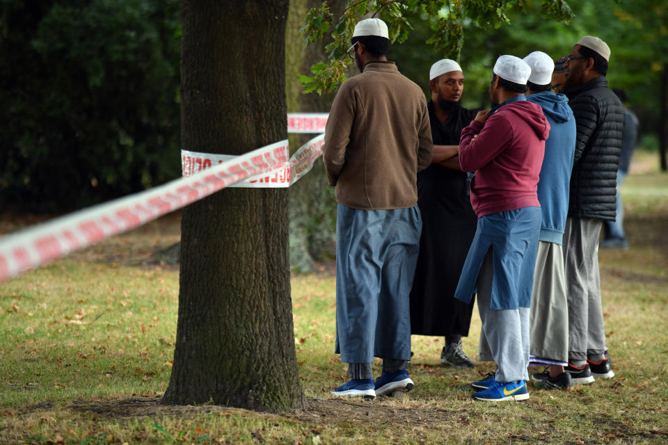 A member of the public places flowers at a makeshift memorial near the Linwood Mosque in Christchurch. Source: AAP