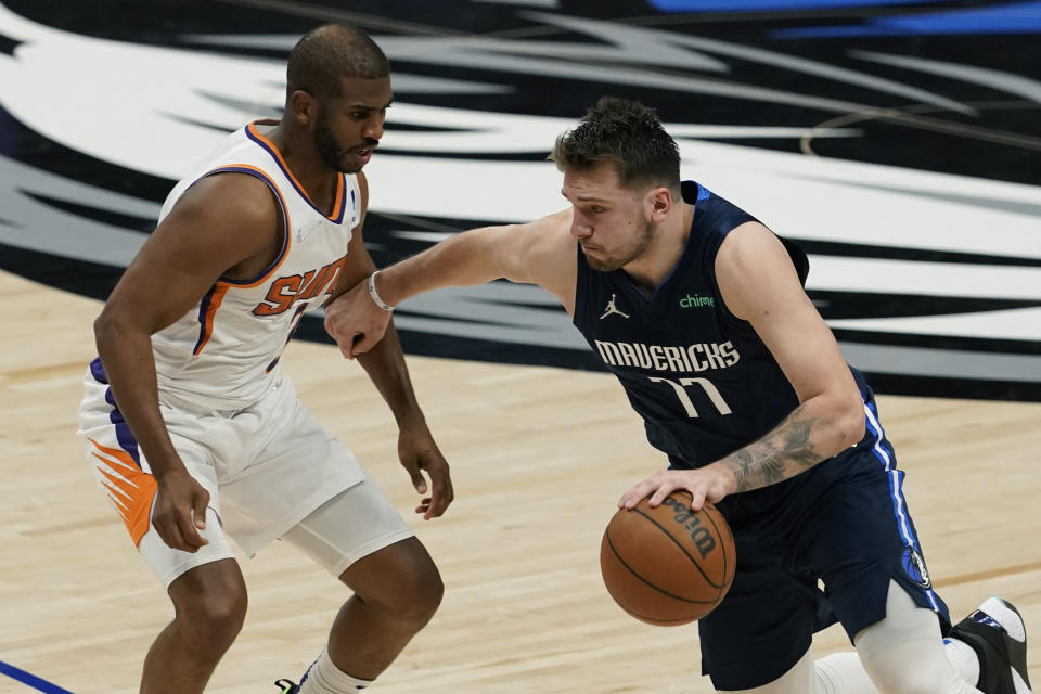 Dallas Mavericks guard Luka Doncic (77) drives with the ball against Phoenix Suns guard Chris Paul, left, during the second half of Game 6 of an NBA basketball second-round playoff series, Thursday, May 12, 2022, in Dallas. (AP Photo/Tony Gutierrez)