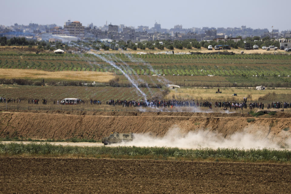 Israeli troops fire tear gas at Palestinian protestord at he Israel and Gaza border fence, Wednesday, May 15, 2019. Palestinians are marking the 71st anniversary of their mass displacement during the 1948 war around Israel's creation. Demonstrations were held across the Israeli-occupied West Bank and the Gaza Strip on Wednesday to mark what the Palestinians call the "nakba," or "catastrophe." (AP Photo/Tsafrir Abayov)