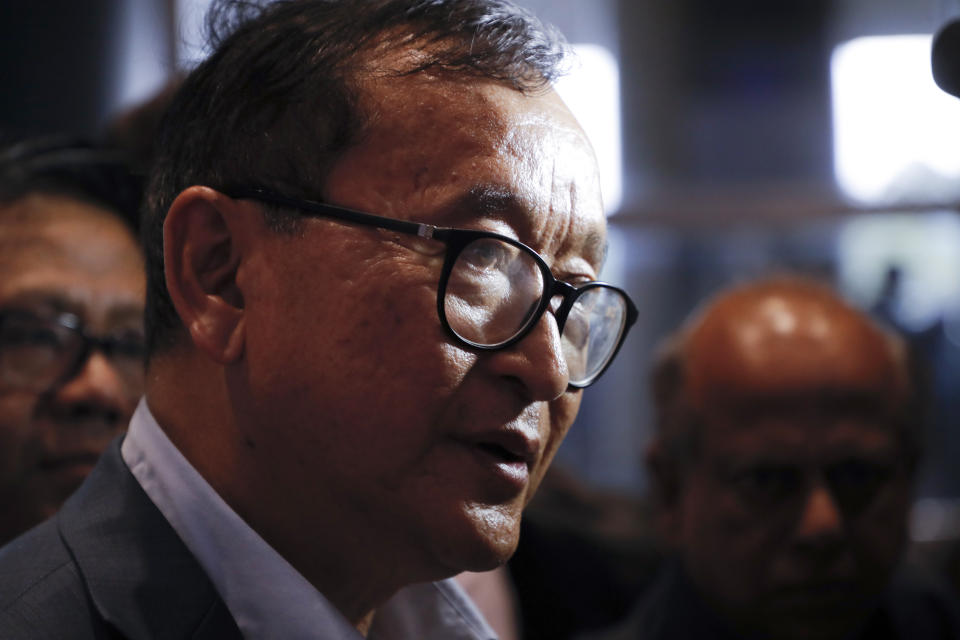 Cambodia's exiled opposition leader Sam Rainsy talks with the media as he arrived at Kuala Lumpur International's Airport in Sepang, Malaysia Saturday, Nov. 9, 2019. Sam Rainsy landed in Kuala Lumpur in a bid to return to his homeland after Thailand had earlier blocked him from entering. (AP Photo/Vincent Thian)