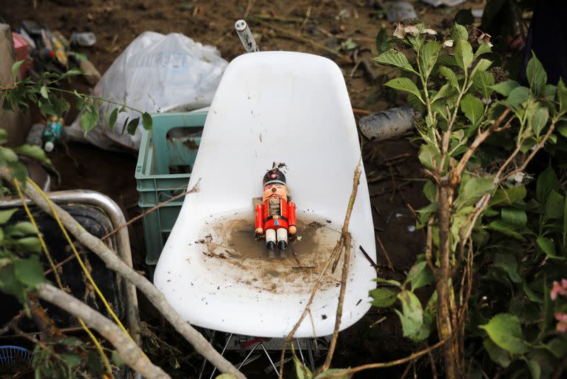 A toy soldier figure is seen amid debris at a damaged house after floods caused by torrential rain in Hitoyoshi, Kumamoto Prefecture