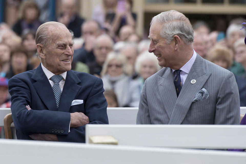 Britain's Prince Philip, Duke of Edinburgh (L) and Prince Charles, Prince of Wales (R) listen to speeches before a statue of the Queen Elizabeth The Queen Mother was unveiled whilst on a visit to the town of Poundbury, southwest England, on October 27, 2016. The Queen and The Duke of Edinburgh, accompanied by The Prince of Wales and The Duchess of Cornwall, visited Poundbury. Poundbury is an experimental new town on the outskirts of Dorchester in southwest England designed by Leon Krier with traditional urban principles championed by The Prince of Wales and built on land owned by the Duchy of Cornwall. / AFP / POOL / JUSTIN TALLIS        (Photo credit should read JUSTIN TALLIS/AFP via Getty Images)