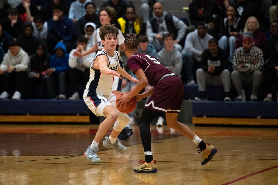 Central Bucks East junior Jake Cummiskey defends Abington junior Jeremiah Lee during the Patriots' 59-46 win in Tuesday night's District One Class 6A second-round playoff game.