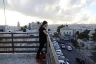 Palestinian Tamara Abu-Laban, 16, looks at the view from a rooftop during her interview with Reuters at her house in East Jerusalem October 8, 2017. Picture taken October 8, 2017. REUTERS/Ammar Awad