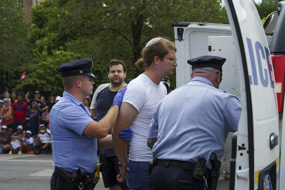 FILE - In this July 4, 2019, file photo, protesters are arrested by Philadelphia police after interrupting The Salute to America Independence Day Parade held near Independence Hall in Philadelphia. A fledgling coalition of liberal Jewish groups is increasingly making itself heard as it fights the Trump administration’s immigration policies. (Jessica Griffin/The Philadelphia Inquirer via AP, File)