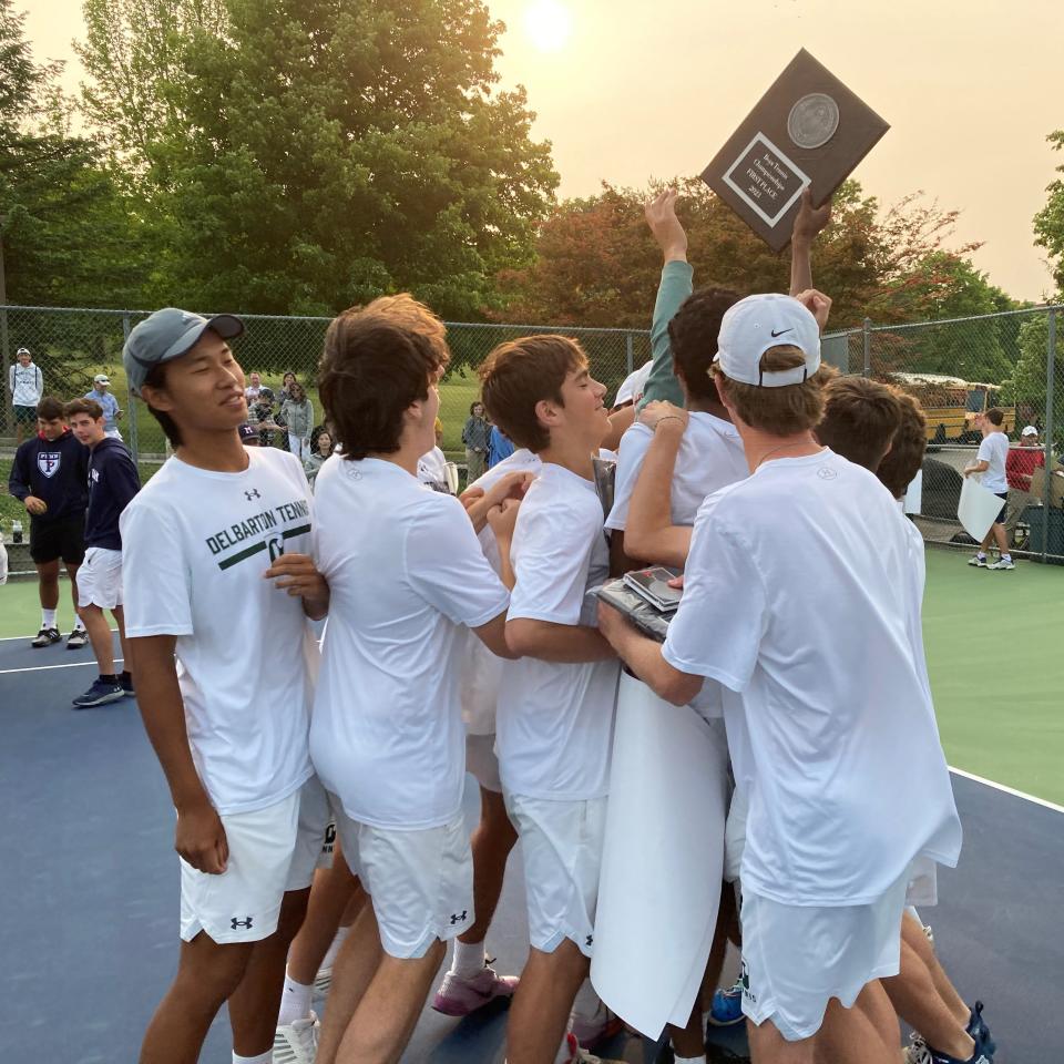 Delbarton co-captain Arjun Bobba  presents the Morris County Tournament plaque to his teammates after outlasting Chatham and Mendham on May 22, 2023.