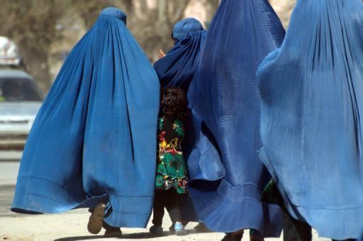 A girl walks with a group of burqa-clad women in the Afghanistan's Takhar province. In a widely-reported "attack" last week, more than 120 girls from a school in northern Takhar province were rushed to hospital after scores fainted and others complained of feeling ill